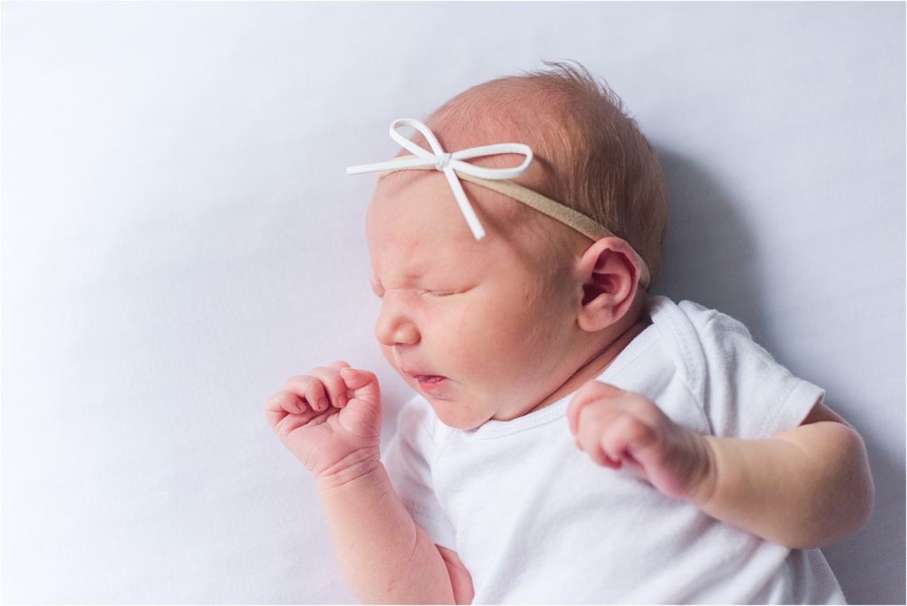 newborn white onesie and bow