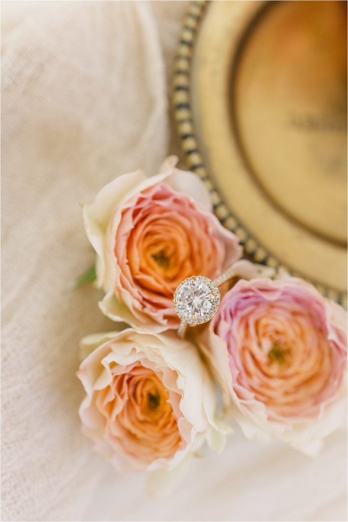 halo engagement ring with flowers and gold tray. Westwind Hills luxury wedding inspiration | Kelsey Alumbaugh Photography | #weddinginspiration #luxurywedding #stlouisweddingphotography #stlwedding #styledshootsacrossamerica
