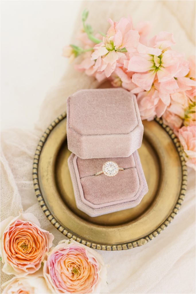 halo engagement ring in blush ring box on gold tray. Westwind Hills luxury wedding inspiration | Kelsey Alumbaugh Photography | #weddinginspiration #luxurywedding #stlouisweddingphotography #stlwedding #styledshootsacrossamerica