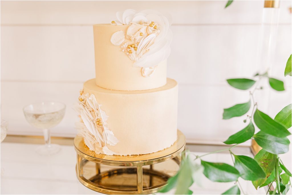 additional wedding cake - tan with embellishments blush and white tiered wedding cake with satin ribbon with gold shelves of wedding desserts Westwind Hills luxury wedding inspiration | Kelsey Alumbaugh Photography | #weddinginspiration #luxurywedding #stlouisweddingphotography #stlwedding #styledshootsacrossamerica