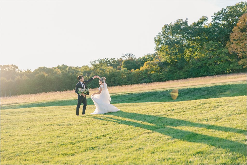 bride and groom in golden hour sunlight drench fall colored field at westwind hills outside st. louis mo additional wedding cake - tan with embellishments blush and white tiered wedding cake with satin ribbon with gold shelves of wedding desserts Westwind Hills luxury wedding inspiration | Kelsey Alumbaugh Photography | #weddinginspiration #luxurywedding #stlouisweddingphotography #stlwedding #styledshootsacrossamerica