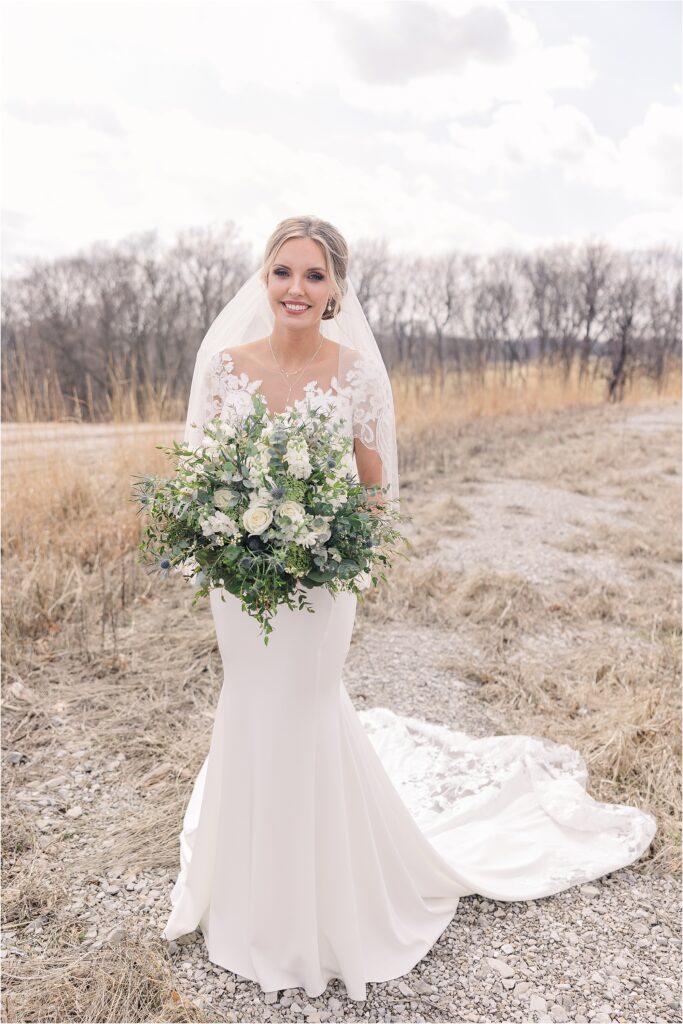 bridal portraits with white and blue bouquet with tons of greenery at Eagle Bluff Ranch, Waverly, Mo - Haylee + Blake | Missouri River spring wedding | Kansas City wedding photographer | Kelsey Alumbaugh Photogrpahy | #kansascitywedding #missouriweddingphotographer #missourispringwedding