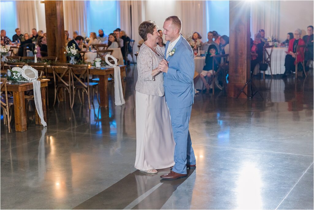 groom and mother dance Blue, white and taupe reception with blue willow vases at Eagle Bluff Ranch, Waverly, Mo - Haylee + Blake | Missouri River spring wedding | Kansas City wedding photographer | Kelsey Alumbaugh Photogrpahy | #kansascitywedding #missouriweddingphotographer #missourispringwedding