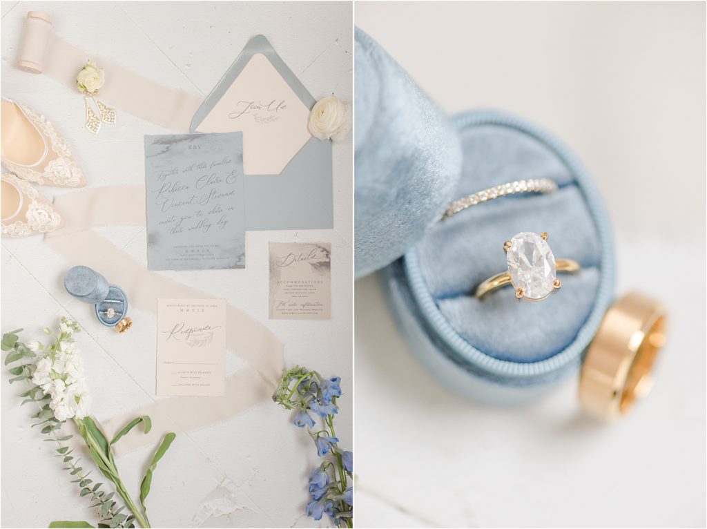 Dusty blue ring box with gold rings and invitation suite