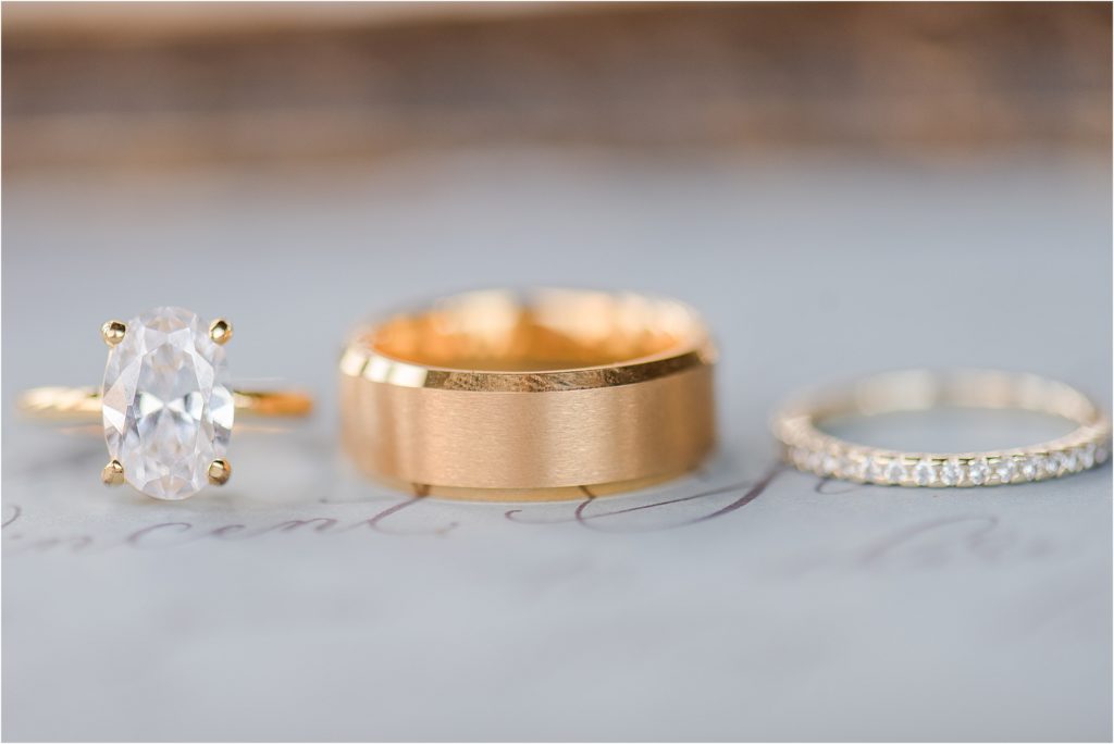 Gold wedding rings and dusty blue invitation - KC Missouri wedding photographer